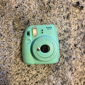 teal polaroid camera